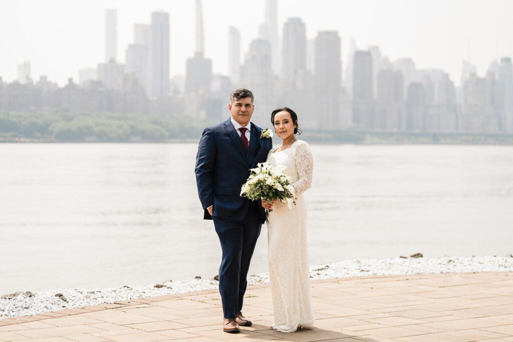 Couple portrait at Waterside Restaurant with Manhattan skyline backdrop by Bergen County photographer Alex Kaplan