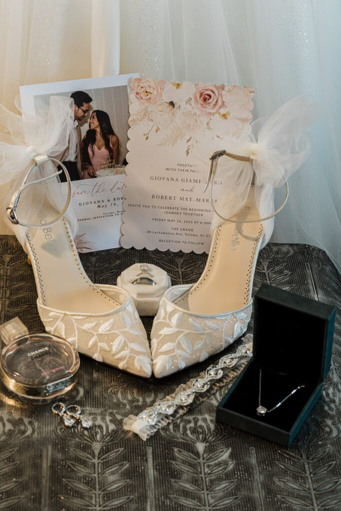 Wedding invitation with Belle shoes and rings flat lay The Grand Totowa NJ