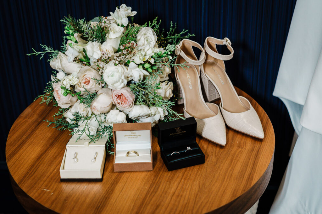Wedding detail photo showing bride's shoes, bouquet, and rings by Alex Kaplan Photography