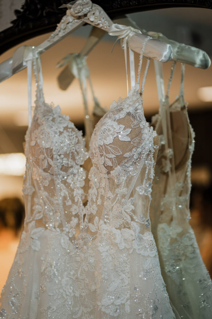 Beaded lace wedding dress detail on hanger The Grand Totowa NJ
