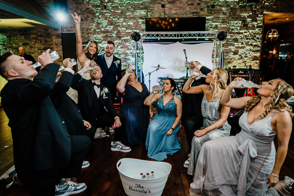 Wedding party icing tradition with Smirnoff Ice at 618 Restaurant Freehold Township NJ reception by Alex Kaplan Photography