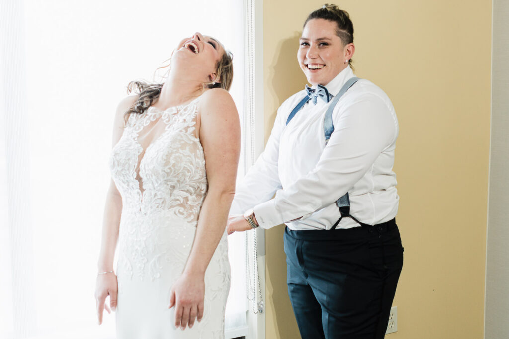 Bride Elyssa laughing with maid of honor Amanda Windsor Ballroom