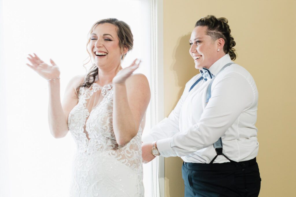 Bride celebrating with maid of honor before first look Windsor Ballroom