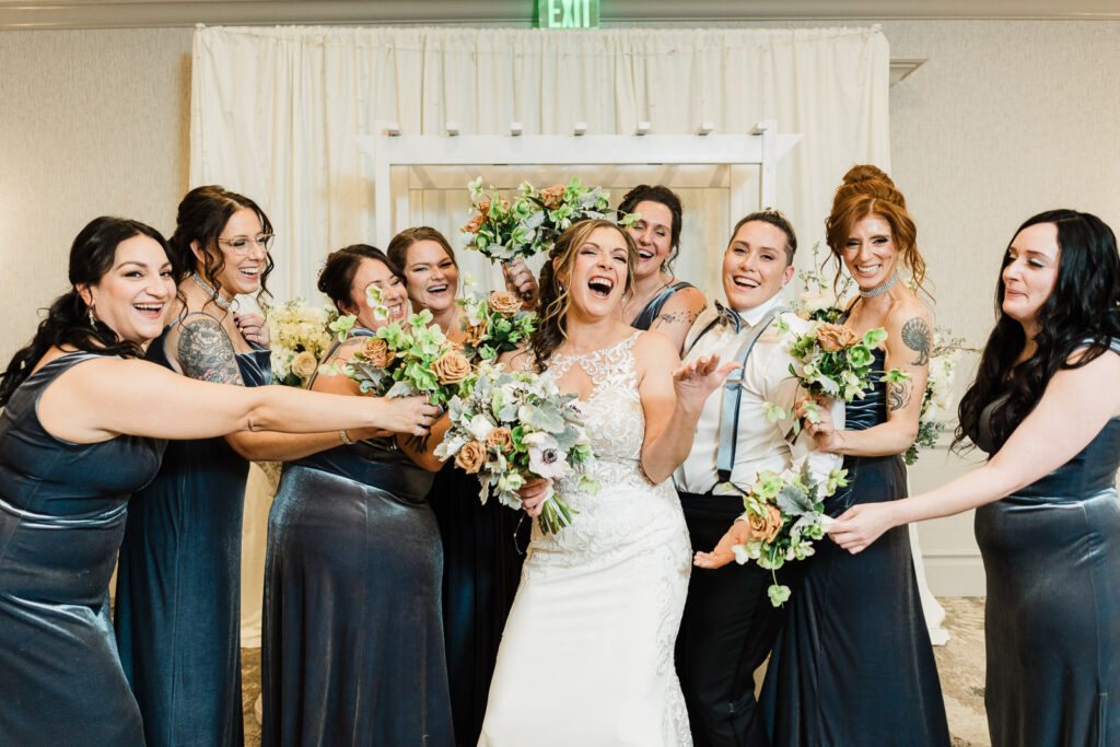 Bride and bridesmaids playful bouquet moment Windsor Ballroom East Windsor