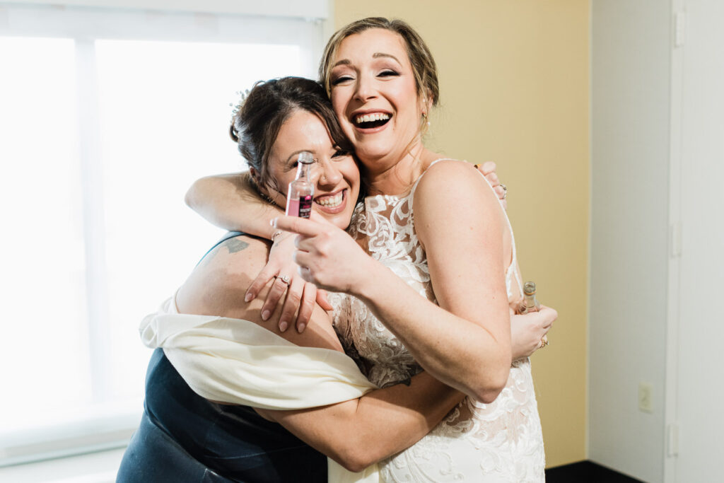 Emotional embrace between bride and bridesmaid Windsor Ballroom wedding