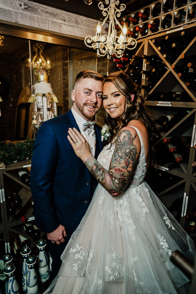 Bride and groom wedding portrait in wine cellar at 618 Restaurant Freehold Township NJ with chandelier and wine racks photographed by Alex Kaplan