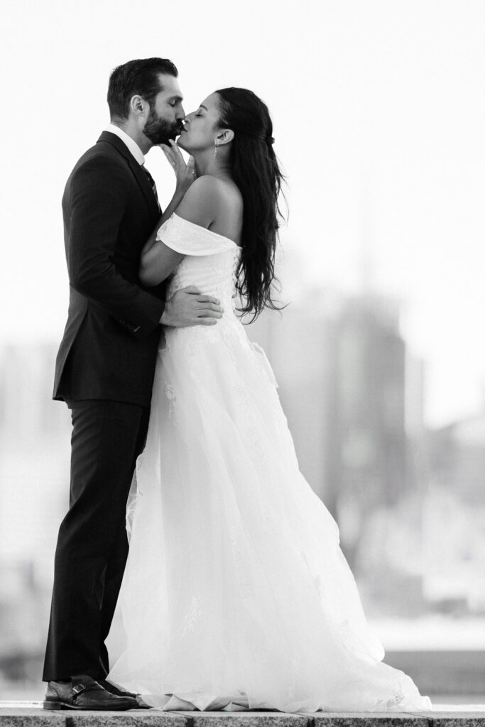 Black and white wedding photo Joanna and Alex almost kissing NYC skyline background Port Imperial timeless portrait