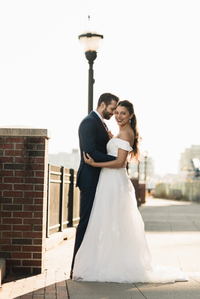 Joanna and Alex romantic portrait with lamppost and Manhattan skyline at Port Imperial West New York wedding photos
