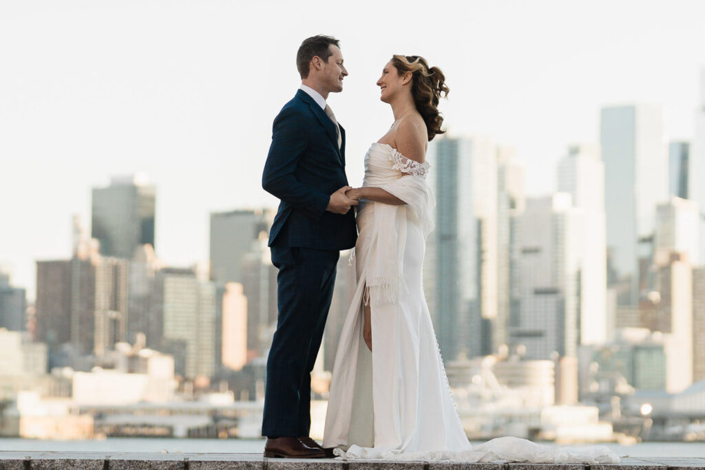 Luz and Stephan during golden hour with NYC skyline Port Imperial West New York romantic wedding photography