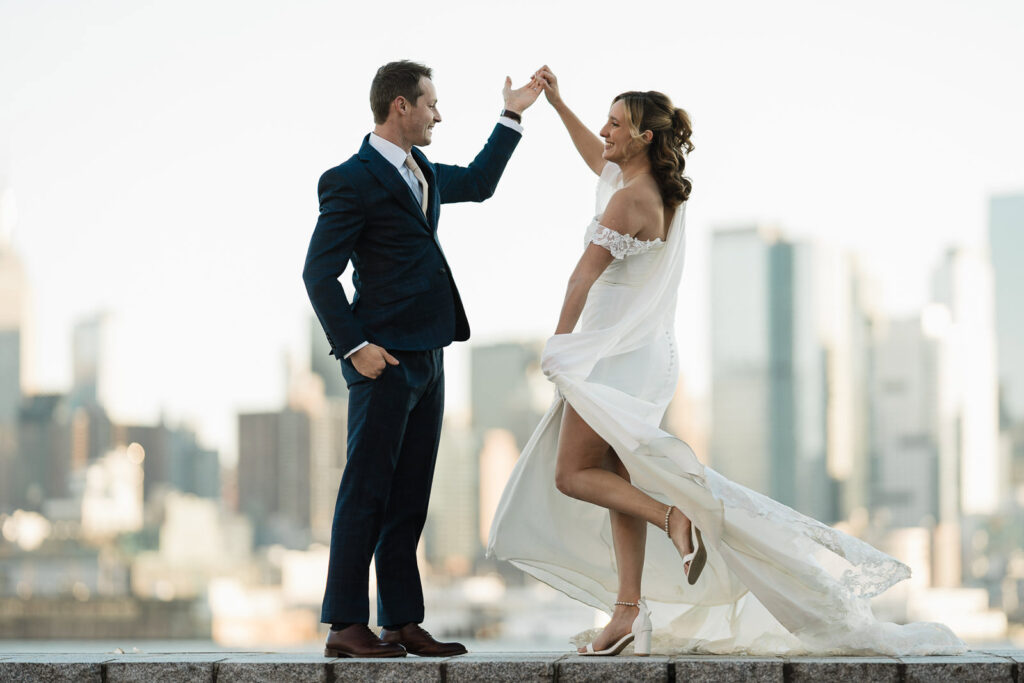 Stephan twirling Luz on Port Imperial waterfront with NYC skyline wedding photography West New York NJ