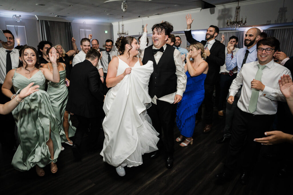 Couple celebrating with guests on dance floor at northern New Jersey wedding reception