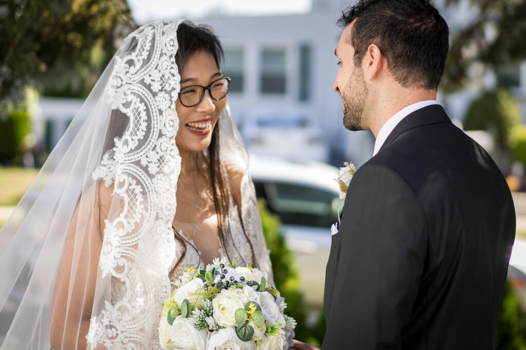 Rob and Ruby couple portrait after first look at Fair Lawn home wedding with cathedral veil and light blue wedding colors