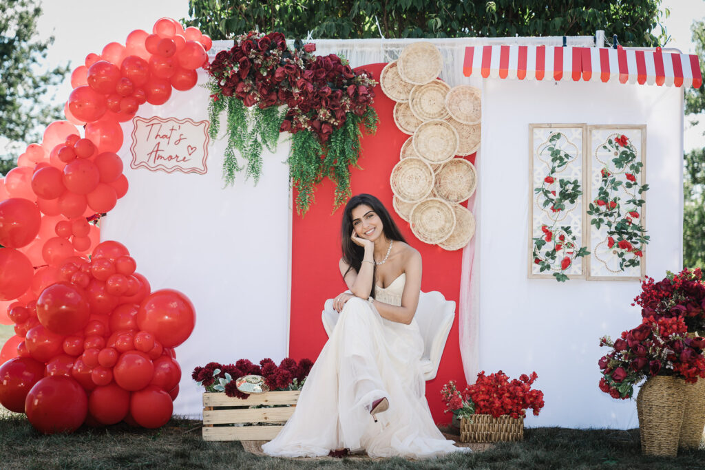 Bride seated at That's Amore backdrop in Somerset NJ backyard