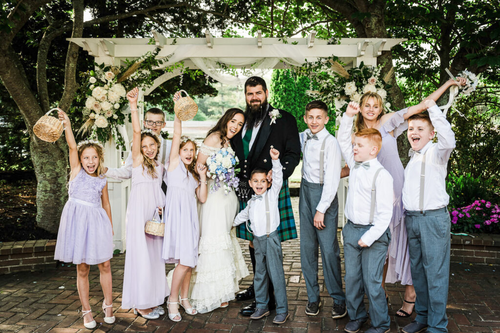 Wedding couple with flower girls and ring bearers at Smithville Inn by Alex Kaplan