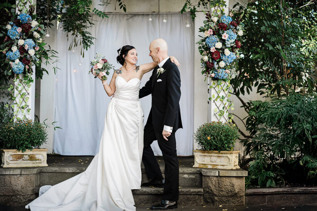Wedding ceremony first kiss under floral arch