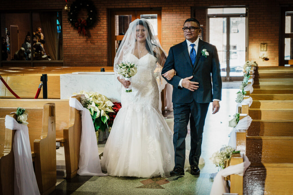 Bride walking down aisle with father at St Theresa Church Kenilworth