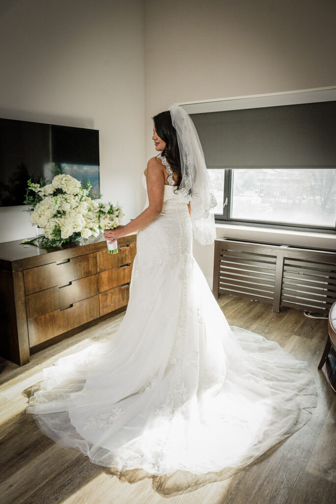 Bride in lace mermaid gown with cathedral veil and white lily bouquet at Watt Hotel Rahway