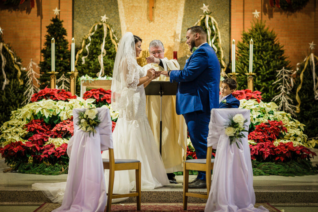 Ring exchange with priest and ring bearer at St Theresa Kenilworth
