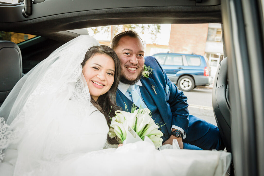 Newlyweds in limo after St Theresa Church ceremony by Alex Kaplan