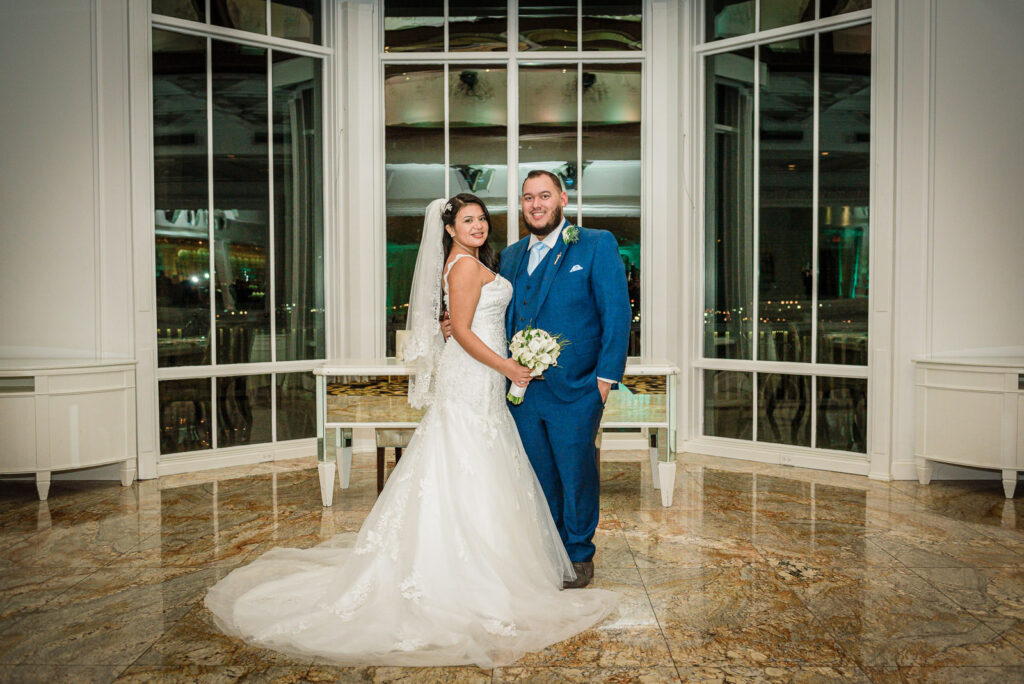 Couple portrait by bay windows at Westmount Country Club Woodland Park