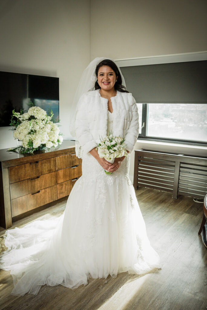 Bride in white fur stole over lace dress with veil at Watt Hotel by Alex Kaplan