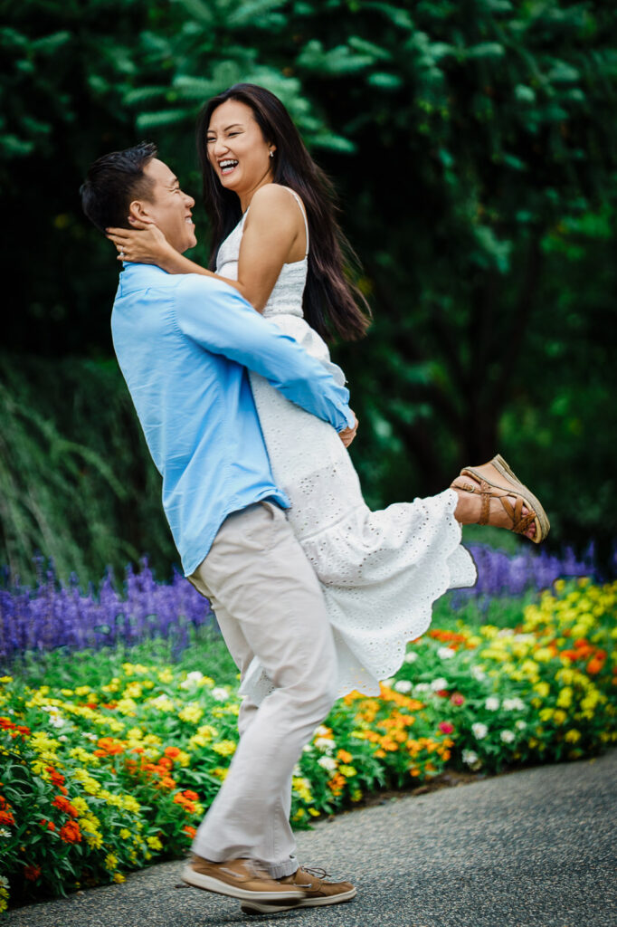 Joyful spinning moment during Deep Cut Gardens engagement session in Middletown