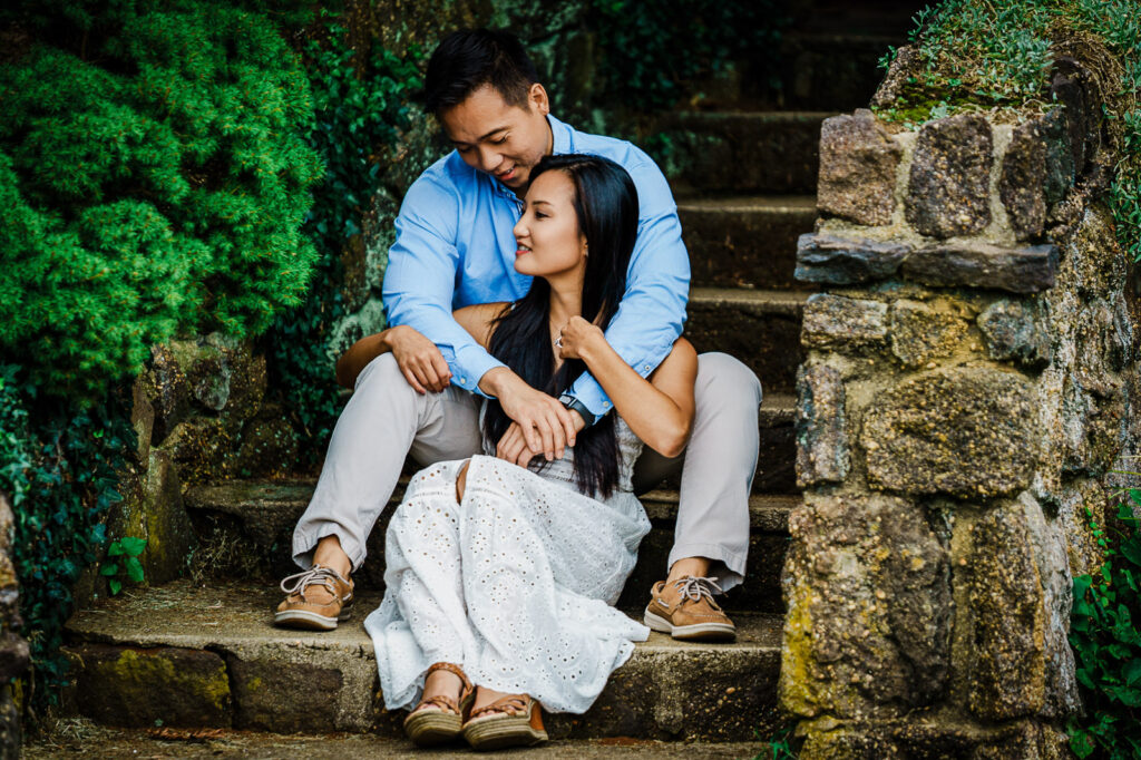Couple on historic stone steps during engagement session at Deep Cut Gardens