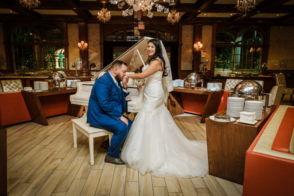 Groom kissing bride's hand at Westmount Country Club cocktail area