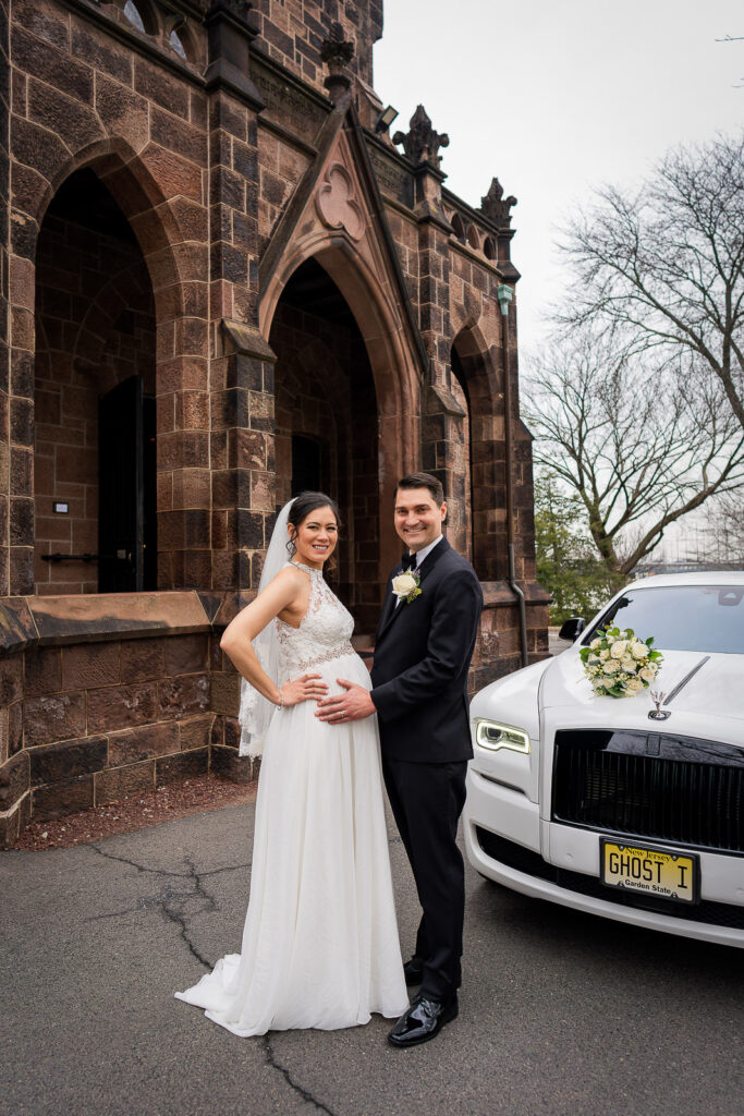 Elegant wedding couple portrait with white Rolls Royce at historic Kirkpatrick Chapel with Gothic architecture, New Brunswick wedding by Alex Kaplan
