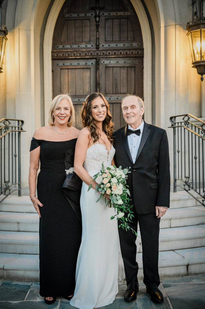 Bride with parents formal portrait at Park Chateau Gothic chapel East Brunswick NJ