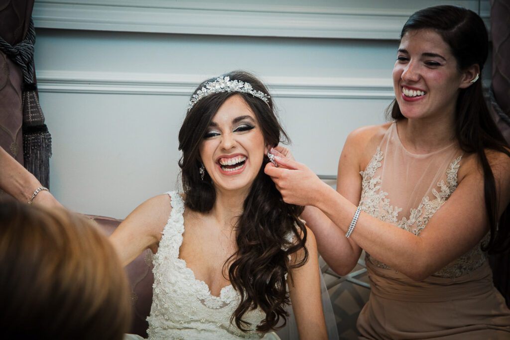 Bride laughing with bridesmaids during getting ready at Rockleigh Country Club wedding