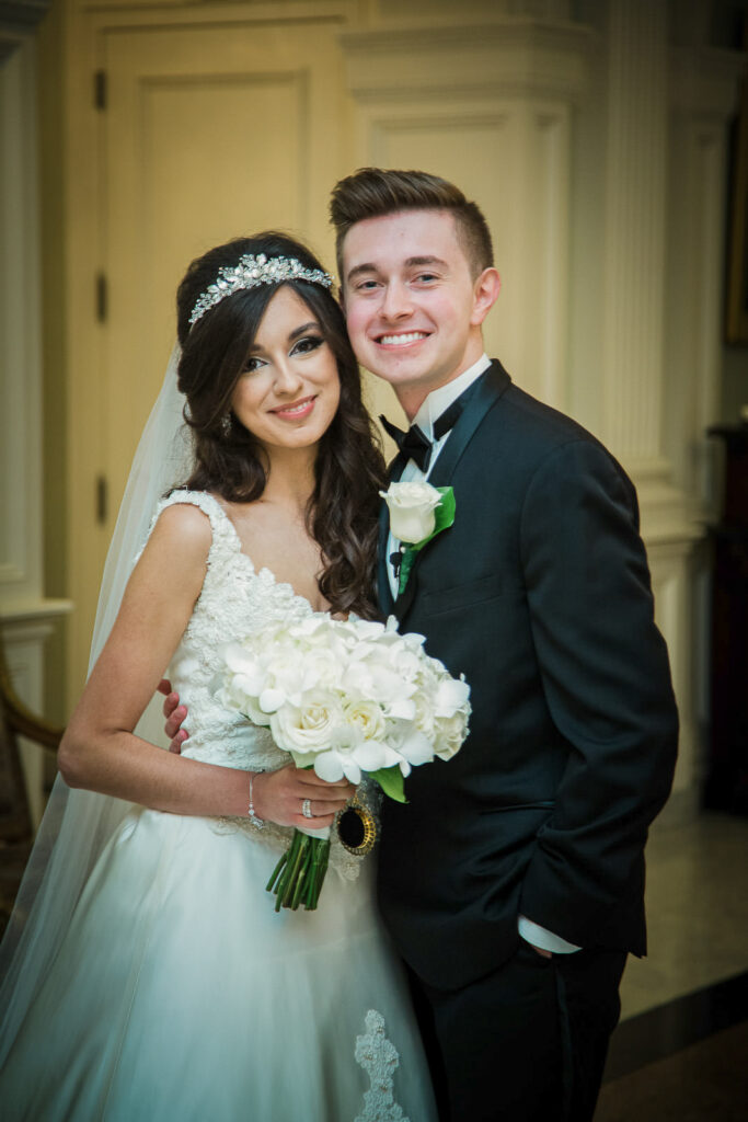Bride and groom portrait in front of stone wall at Rockleigh Country Club
