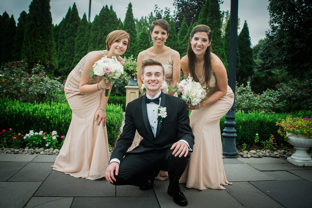 Bride with bridesmaids in champagne dresses at Rockleigh Country Club gardens