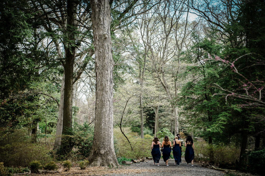 Bridesmaids walking garden path at Rockleigh Country Club