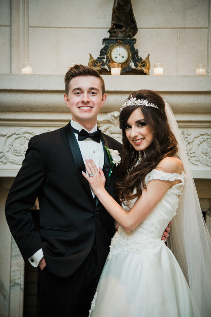 Bride and groom portrait by fireplace at Rockleigh Country Club wedding