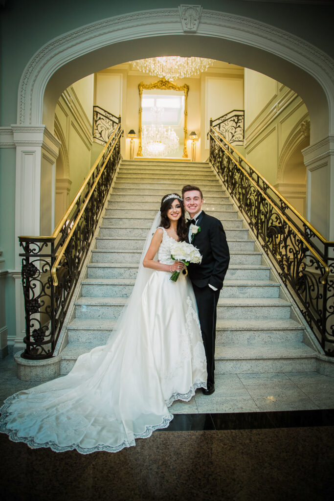 Wedding couple portrait on the iconic grand staircase at Rockleigh Country Club