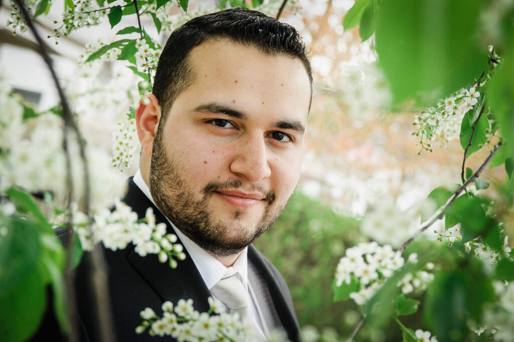 Groom portrait among spring blossoms at Rockleigh Country Club