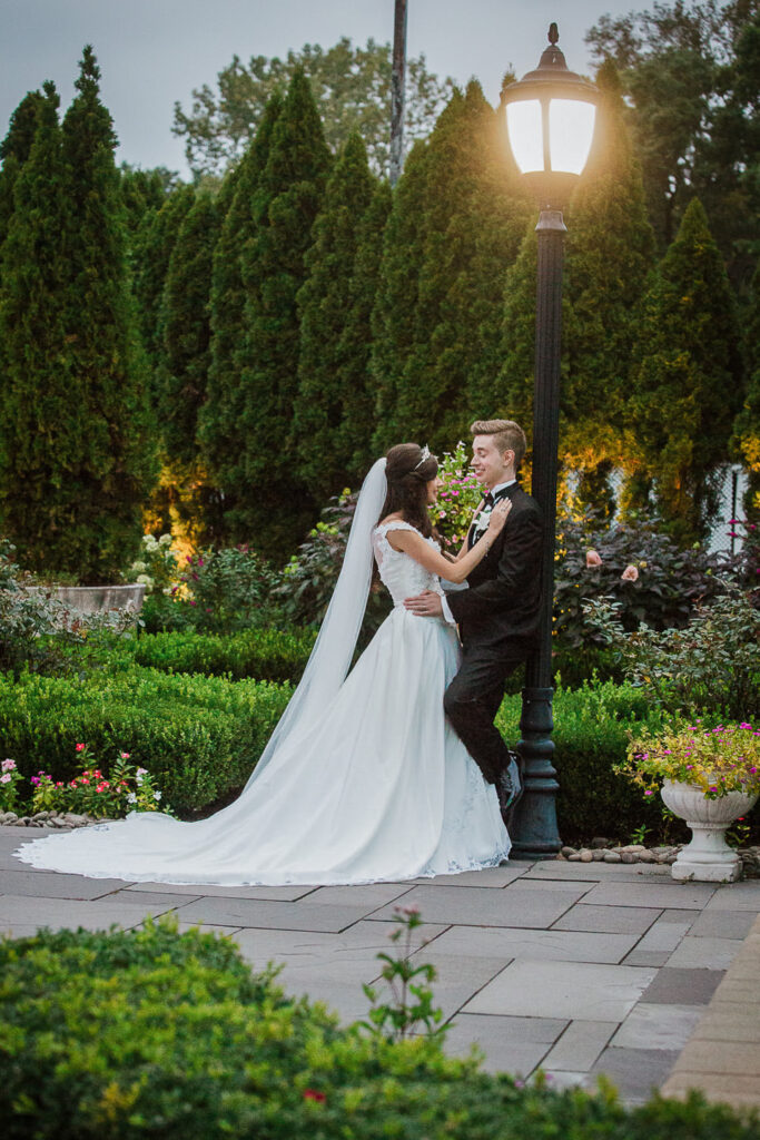 Romantic sunset portrait of bride and groom by lamp post at Rockleigh Country Club