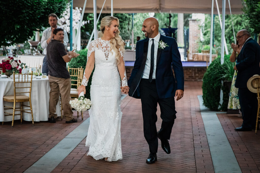 Bride and groom exchanging vows during outdoor ceremony at Rockleigh