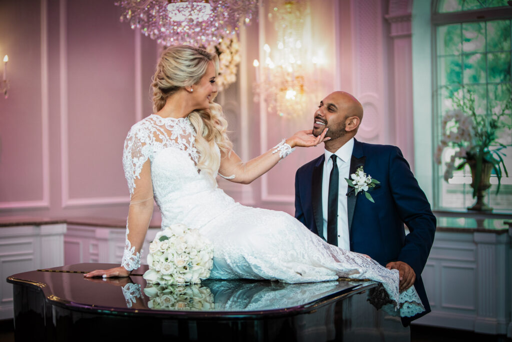 Couple sharing playful moment by fountain at Rockleigh wedding