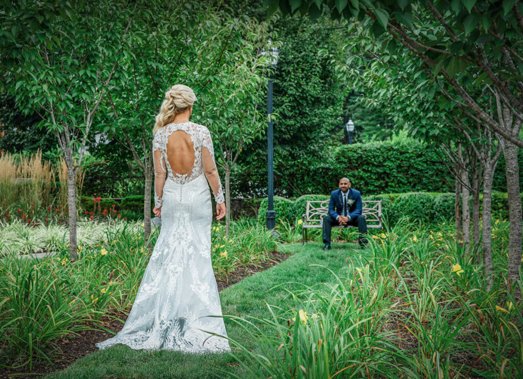 Couple's first look in garden setting at Rockleigh Country Club wedding