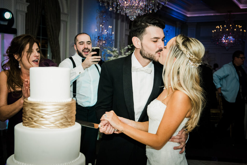 Bride groom kissing cake cutting Rockleigh Country Club