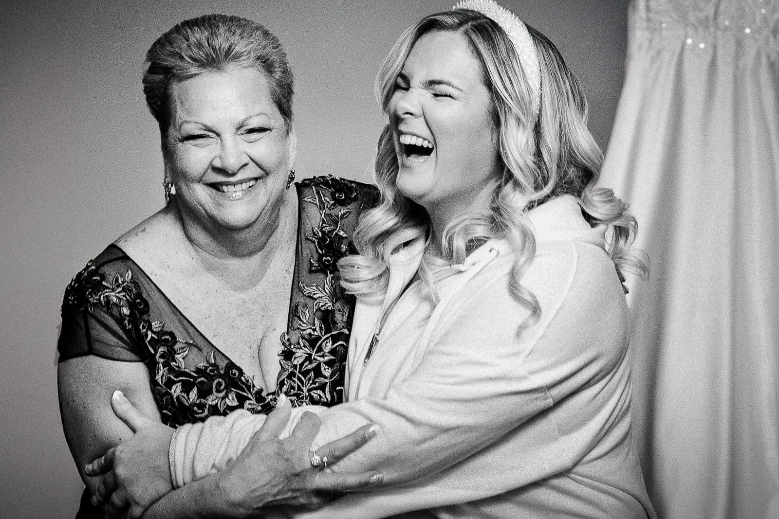 Bride and mother laughing together during getting ready at The Palace at Somerset Park wedding