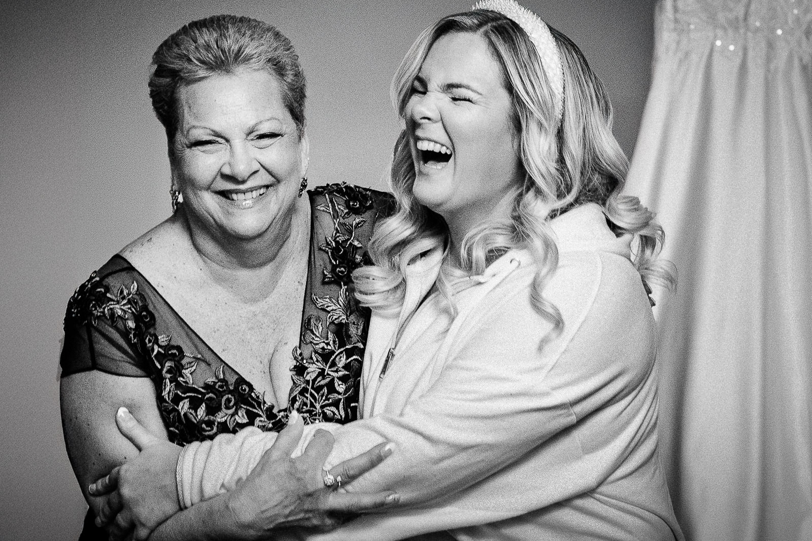 Bride and mother laughing together during getting ready at The Palace at Somerset Park wedding