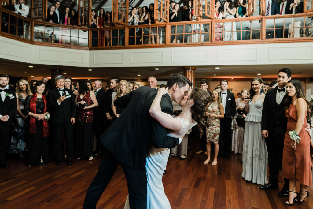 First dance romantic dip with bride and groom kissing at Metropolitan Caterers Glen Cove ballroom reception