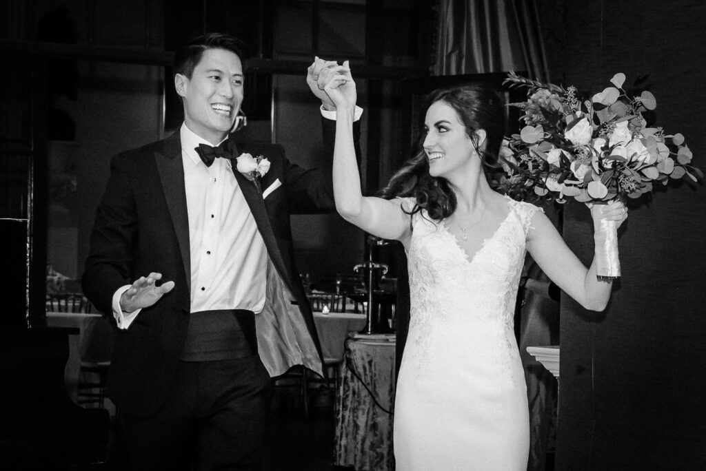 Bride and groom grand entrance celebration at Metropolitan Caterers Glen Cove NY with guests cheering