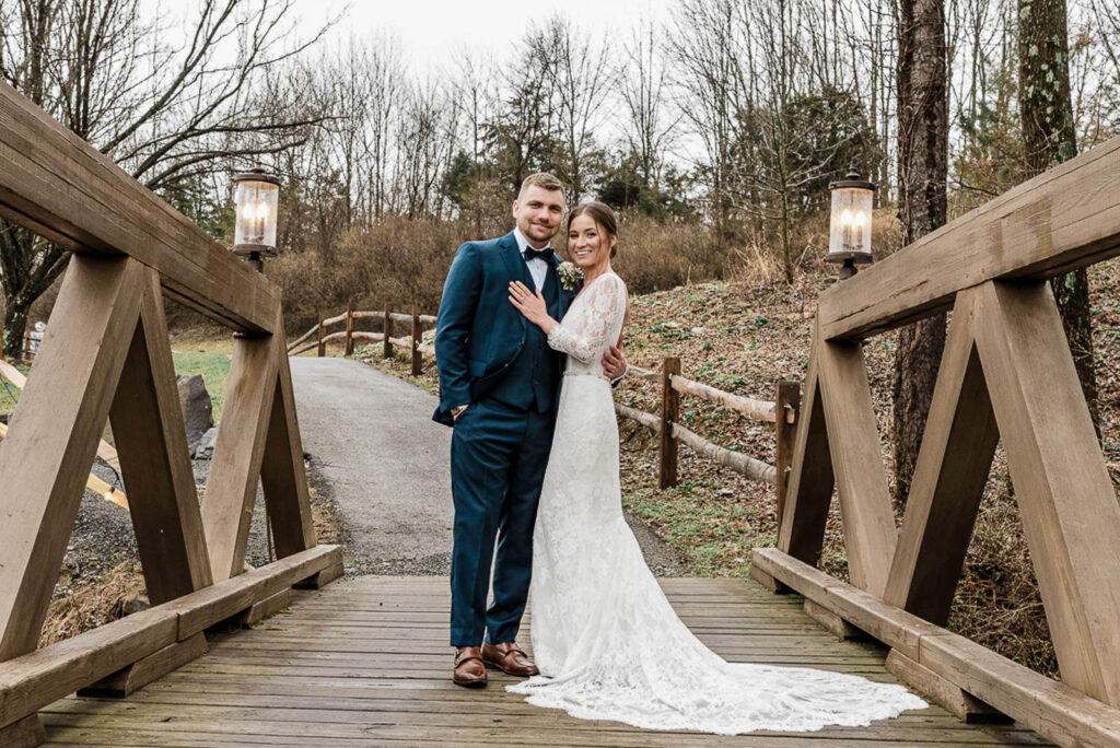 Bride and groom on wooden bridge at Hamilton Farm Golf Club