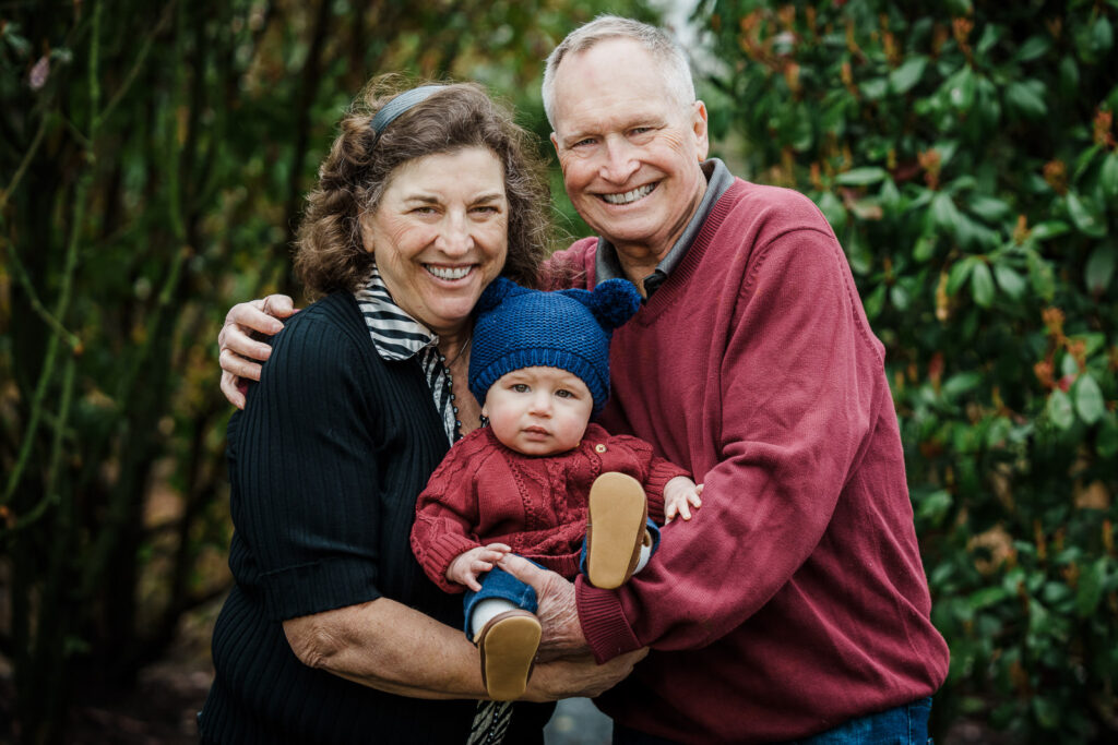 Grandparents holding baby outdoors at Knight Park in Collingswood