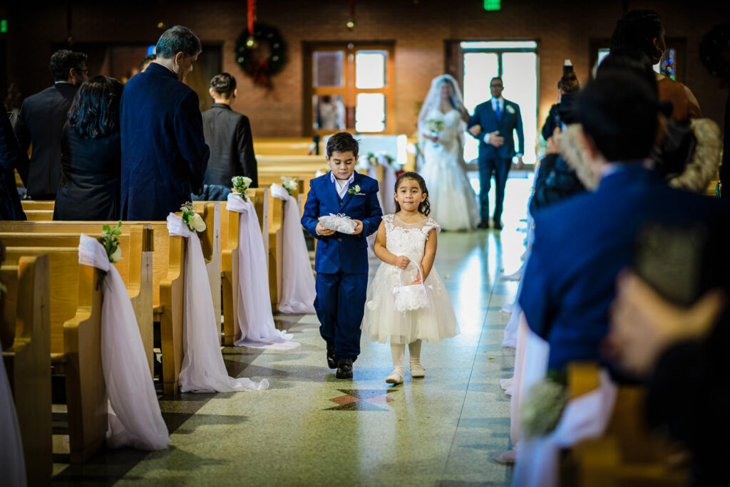 Ring bearer and flower girl processional at St Theresa Church by Alex Kaplan