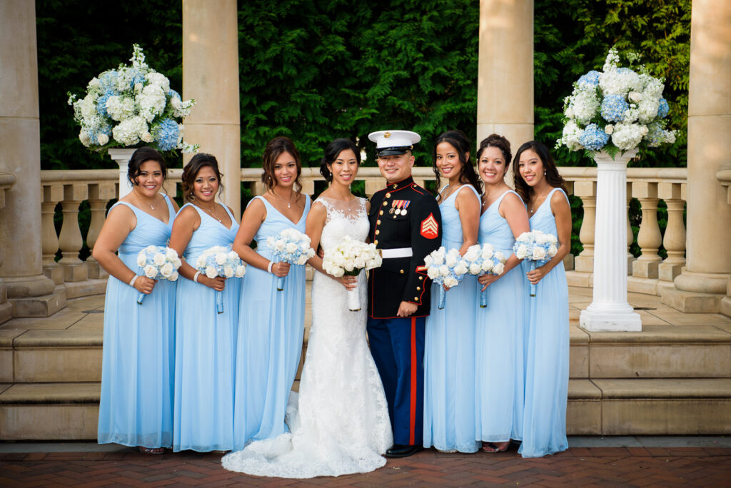 Marine groom and bride with bridesmaids on steps at Rockleigh Country Club